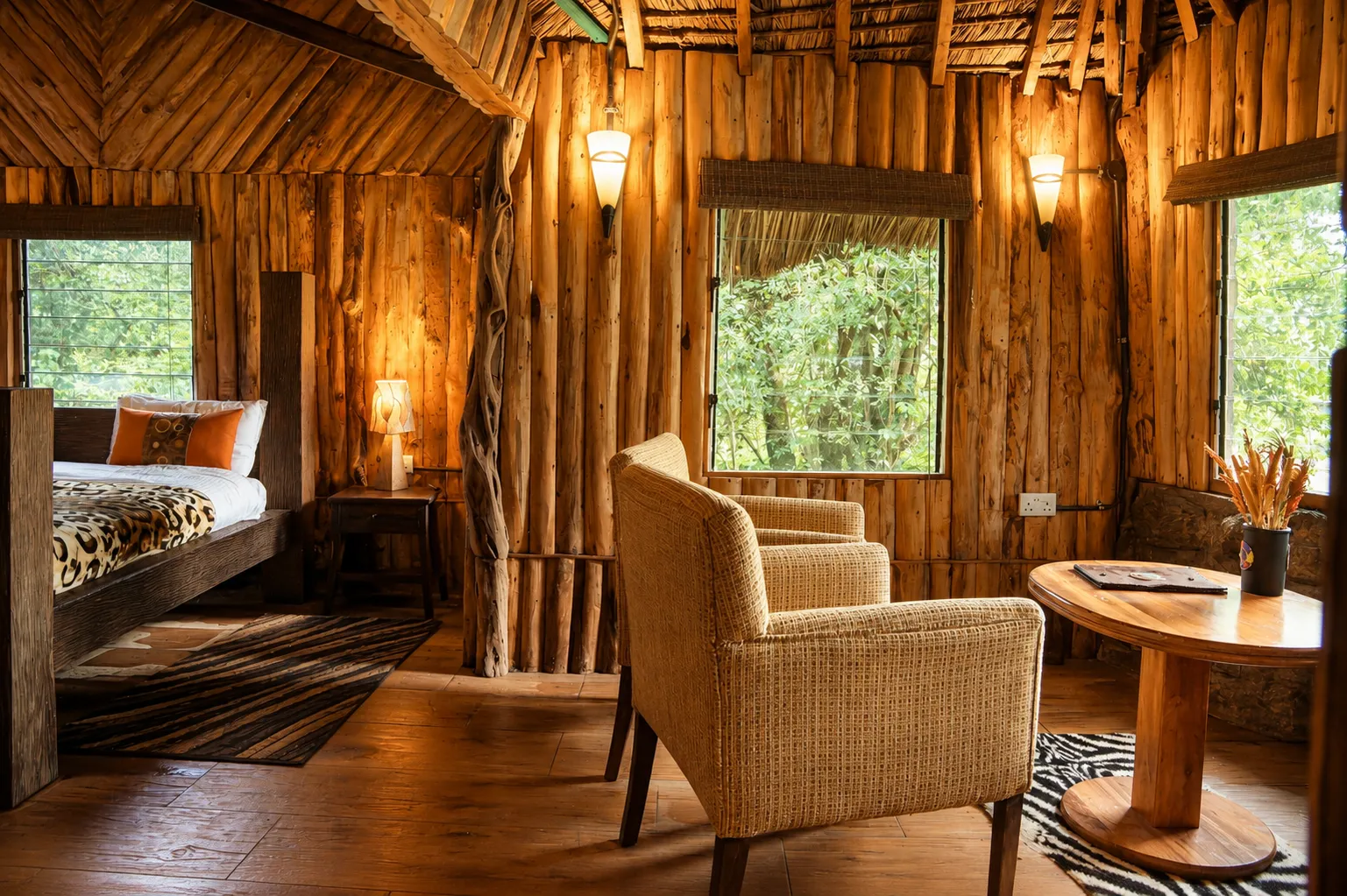 Cozy wooden cabin interior with comfortable armchairs and rustic log walls at Simba's Den, Exploreans Mara River Camp