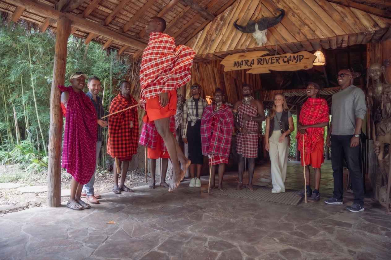 Maasai warriors performing traditional dance during a guided village visit, Maasai Mara Kenya