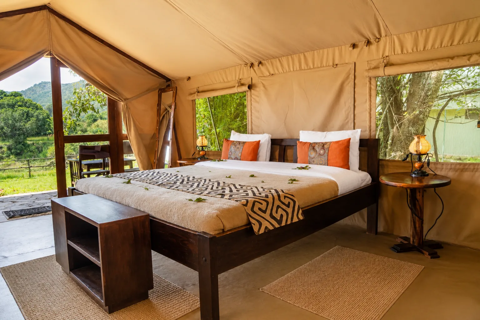 Comfortable king-size bed inside a canvas safari tent at Exploreans Mara River Camp, Masai Mara, Kenya