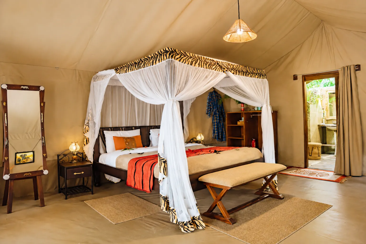 Interior view of a secluded luxury bush tent looking out to lush green wilderness in Masai Mara, Kenya