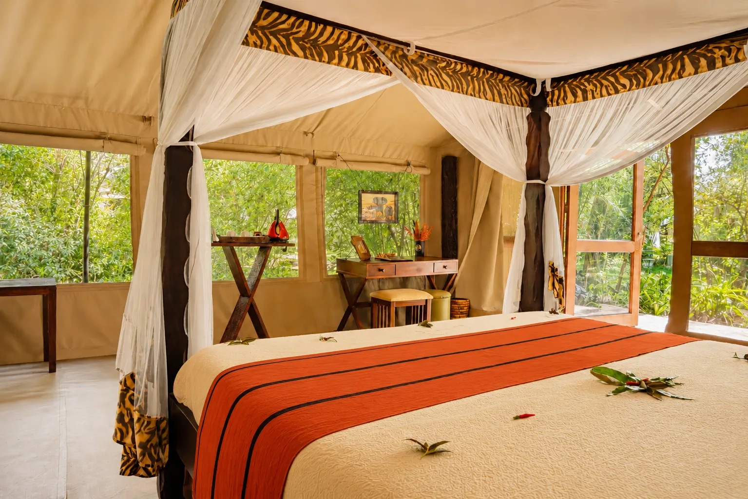 Romantic safari tent bedroom featuring African decor at Exploreans Mara River Camp